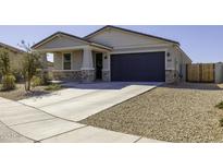 Charming single-story home with a well-maintained lawn and a two-car garage and stone veneer at 281 S San Gregorio Ln, Casa Grande, AZ 85194