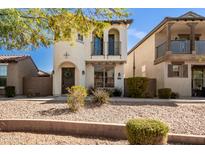 Charming two-story home featuring a turret-style entry, arched windows, and a small balcony at 3002 N Sonoran Hls, Mesa, AZ 85207