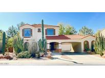 Charming two-story home featuring a terracotta roof, stucco exterior, and desert landscaping at 3807 E Latham Ct, Gilbert, AZ 85297