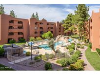 Stunning outdoor community pool area with water feature, mature trees, and seating at 4303 E Cactus Rd # 308B, Phoenix, AZ 85032
