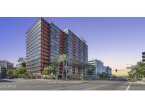 Modern high-rise building featuring extensive glass facade and street-level palm tree landscaping at 4808 N 24Th St # 1305, Phoenix, AZ 85016