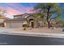 Beautiful stucco home with desert landscaping, three-car garage and tile roof at 10917 E Raintree Dr, Scottsdale, AZ 85255