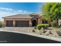 Charming home featuring a tile roof, three-car garage and professionally landscaped yard in a great neighborhood at 17302 N 99Th Pl, Scottsdale, AZ 85255