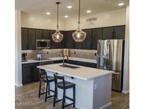 Modern kitchen with stainless steel appliances, stylish pendant lighting, and a large center island at 250 W Queen Creek Rd # 229, Chandler, AZ 85248