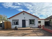 Charming single-story home featuring a red roof, stucco siding, and a small front yard at 2912 E Monroe St, Phoenix, AZ 85034