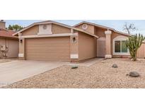 Inviting home with a two-car garage and desert landscaping, offering curb appeal and easy maintenance at 3613 W Camino Real --, Glendale, AZ 85310