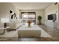 Bright living room with modern furnishings and sliding glass doors leading to the outside at 3825 E Camelback Rd # 292, Phoenix, AZ 85018
