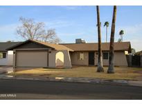 Charming single-story home with a two-car garage and xeriscaped front yard at 419 E Gemini Dr, Tempe, AZ 85283