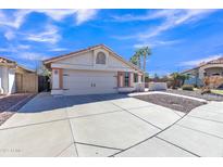 Charming single-story home featuring a two-car garage, desert landscaping, and a well-maintained front yard at 557 S Dodge St, Gilbert, AZ 85233