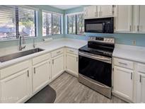 Bright kitchen featuring stainless steel appliances, modern countertops, and ample natural light at 750 E Northern Ave # 2088, Phoenix, AZ 85020