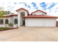 Charming single-Gathering home showcasing a terracotta-tiled roof and a spacious three-car garage at 1402 E Marconi Ave, Phoenix, AZ 85022