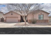 Charming single-story home with well-maintained landscaping and a two-car garage at 1629 E Prickly Pear Pl, Casa Grande, AZ 85122