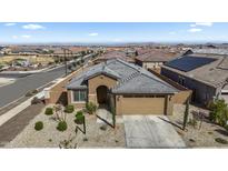 Charming single-story home with a well-manicured front yard and neutral color palette at 16430 W Alameda Rd, Surprise, AZ 85387