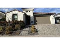 Charming single-Gathering house with a two-car garage, landscaping, and concrete walkway at 17168 W Middlebury St, Surprise, AZ 85388