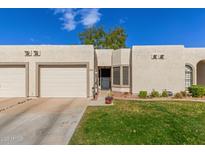 Charming single-story home with a well-maintained lawn and a two-car garage at 18745 N 92Nd Dr, Peoria, AZ 85382