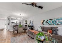 Open-concept living area with a dining table, comfortable seating, and modern décor at 18745 N 92Nd Dr, Peoria, AZ 85382
