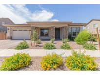 Charming single-story home with stone accents, landscaped front yard, and a two-car garage at 21165 E Thornton Rd, Queen Creek, AZ 85142