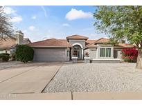 Charming single-story home featuring a well-maintained front yard and a spacious two-car garage at 2906 E Nora St, Mesa, AZ 85213