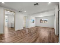 Bright living room featuring wood-look flooring, neutral walls, and natural light at 3104 E Broadway Rd -- # 287, Mesa, AZ 85204