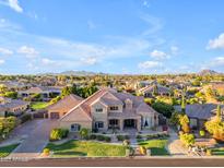 Luxury home with manicured landscaping, mature trees and hardscape in a lush desert neighborhood at 3446 E Knoll St, Mesa, AZ 85213