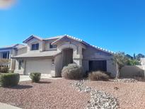 Two-story home featuring a well-manicured yard and a two-car garage at 4150 E Harvard Ave, Gilbert, AZ 85234