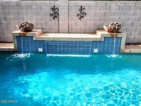 Inviting pool featuring a beautiful water feature and decorative rock-filled bowls, perfect for relaxation at 4150 E Harvard Ave, Gilbert, AZ 85234