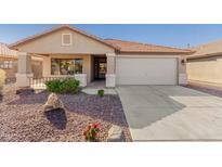 Charming single-story home featuring a well-maintained yard and a spacious two-car garage at 42313 W Sparks Dr, Maricopa, AZ 85138