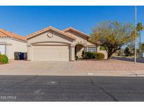 Charming single-story home with a two-car garage, low maintenance desert landscaping and a terracotta-colored roof at 504 W Carmen St, Tempe, AZ 85283