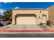 Beige two-car garage attached to a single-story home with desert landscaping and a red painted curb at 625 N Hamilton St # 36, Chandler, AZ 85225