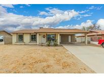 Charming single-story home with a covered carport and well-lit windows showcasing the exterior at 7605 W Avalon Dr, Phoenix, AZ 85033