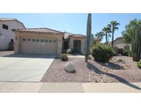 Charming single-story home featuring desert landscaping, gravel, and a two car garage at 9763 W Butler Dr, Peoria, AZ 85345