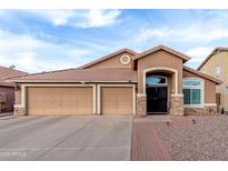 Charming single-story home featuring a three-car garage, low maintenance desert landscaping, and classic Southwestern architecture at 1412 E Erie St, Chandler, AZ 85225