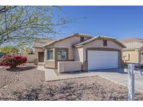 Charming single-story home with a desert landscape and a two car garage under a bright blue sky at 1615 W Hidalgo Ave, Phoenix, AZ 85041