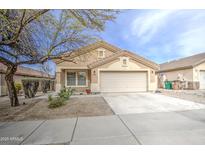 Charming single-story home with desert landscaping, a two-car garage, and a welcoming facade at 17526 W Coyote Trail Dr, Goodyear, AZ 85338