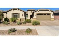 Charming single-story home with a desert landscape, a paver driveway, and a two-car garage at 20520 E Mockingbird Dr, Queen Creek, AZ 85142
