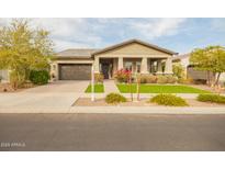 Charming home with a two-car garage, well-maintained landscaping, and a welcoming front porch at 20652 W Clearstream Dr, Buckeye, AZ 85396