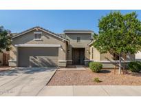 Charming single-story home featuring a two-car garage, landscaped yard, and welcoming front entrance at 21090 E Camina Buena Vis, Queen Creek, AZ 85142