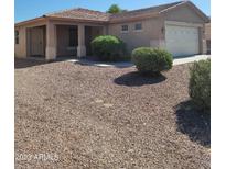 Charming single-story home featuring a well-maintained landscape and a covered porch at 24930 W Dove Mesa Dr, Buckeye, AZ 85326