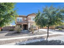 Charming two-story home with stucco exterior, tile roof, and well-maintained landscaping at 2987 E Powell Way, Gilbert, AZ 85298