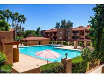 Enjoy the community pool surrounded by lush landscaping and resort-style living at 3031 N Civic Center Plz # 205, Scottsdale, AZ 85251