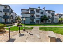 Inviting apartment complex with lush green spaces and community barbeque area at 3848 N 3Rd Ave # 1047, Phoenix, AZ 85013