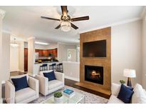 Cozy living room featuring a fireplace and open-concept kitchen, perfect for entertaining guests at 7009 E Acoma Dr # 2134, Scottsdale, AZ 85254
