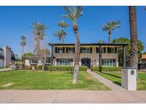 Charming two-story home with meticulous landscaping, a sidewalk, and mature trees at 726 W El Camino W Dr, Phoenix, AZ 85021