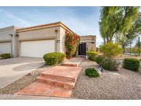 Charming home featuring a well-maintained exterior with a two car garage and landscaped yard at 8401 N 84Th Pl, Scottsdale, AZ 85258