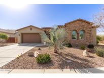 Well-maintained home exterior with desert landscaping and a charming facade at 10835 E Thornton Ave, Mesa, AZ 85212