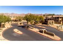 Gated community entrance with desert landscaping and mountain views at 11500 E Cochise Dr # 1094, Scottsdale, AZ 85259
