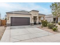 Charming single-story home featuring a two-car garage, desert landscaping, and a welcoming front porch at 1189 E Tyler Ln, Casa Grande, AZ 85122