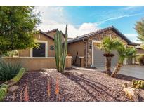 Charming single-story home with desert landscaping, stone accents, and a well-maintained front yard at 20515 N 271St Ave, Buckeye, AZ 85396