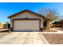 A single-Gathering home featuring a two-car garage and manicured landscaping at 22727 W Papago St, Buckeye, AZ 85326