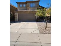 Two story home featuring a two-car garage, well maintained gravel front yard and neutral exterior paint color at 28430 N 51 St, Cave Creek, AZ 85331
